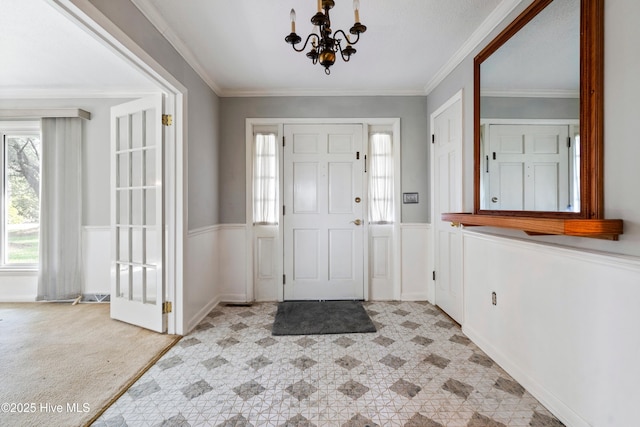 280 Cornwallis Rd, Teachey, NC 28464 - entryway with a chandelier, a wainscoted wall, and ornamental molding