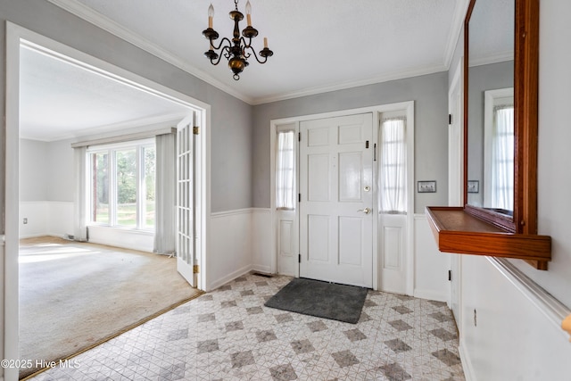 280 Cornwallis Rd, Teachey, NC 28464 - entrance foyer featuring a chandelier, crown molding, a wainscoted wall, and carpet