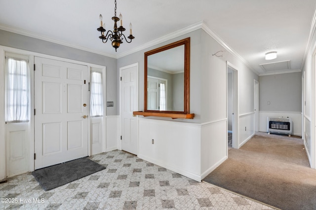 280 Cornwallis Rd, Teachey, NC 28464 - entrance foyer with heating unit, a chandelier, ornamental molding, wainscoting, and light carpet