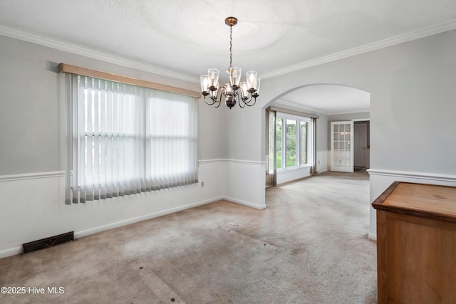 280 Cornwallis Rd, Teachey, NC 28464 - carpeted spare room with arched walkways, ornamental molding, and a chandelier