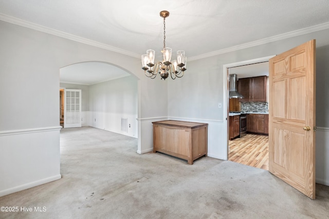 280 Cornwallis Rd, Teachey, NC 28464 - unfurnished dining area featuring arched walkways, light colored carpet, ornamental molding, and a chandelier