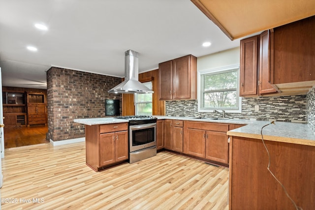 280 Cornwallis Rd, Teachey, NC 28464 - kitchen with gas stove, island range hood, a peninsula, light wood-style floors, and tasteful backsplash