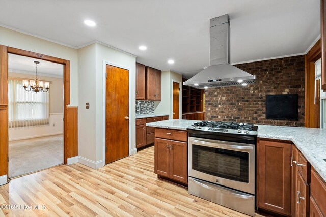 280 Cornwallis Rd, Teachey, NC 28464 - kitchen featuring island exhaust hood, gas stove, crown molding, light wood-style floors, and a chandelier