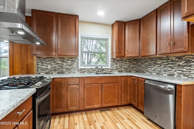 280 Cornwallis Rd, Teachey, NC 28464 - kitchen featuring stainless steel appliances, wall chimney range hood, light wood-type flooring, tasteful backsplash, and recessed lighting