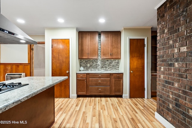 280 Cornwallis Rd, Teachey, NC 28464 - kitchen with ventilation hood, light wood-style floors, tasteful backsplash, crown molding, and stainless steel gas stovetop