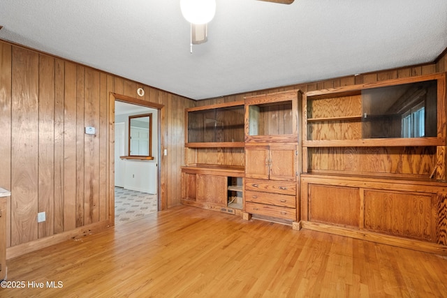 280 Cornwallis Rd, Teachey, NC 28464 - unfurnished office featuring wood walls, light wood-type flooring, and a ceiling fan