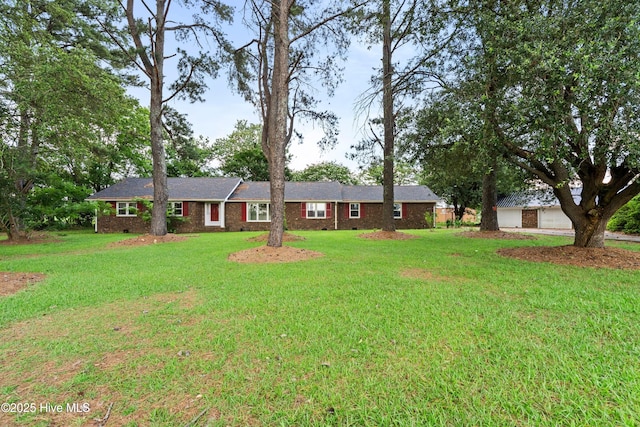 280 Cornwallis Rd, Teachey, NC 28464 - ranch-style house featuring a front yard, brick siding, and a detached garage