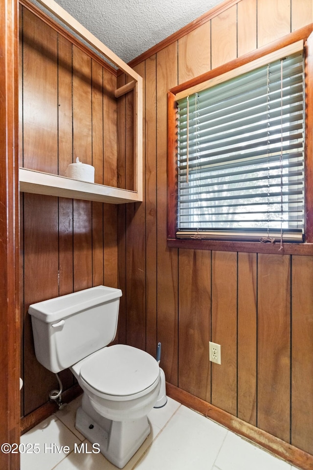 280 Cornwallis Rd, Teachey, NC 28464 - bathroom with wood walls, a textured ceiling, tile patterned flooring, plenty of natural light, and crown molding