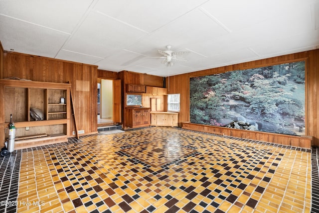 280 Cornwallis Rd, Teachey, NC 28464 - unfurnished living room featuring wood walls and a ceiling fan