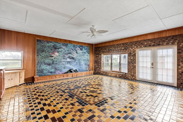 280 Cornwallis Rd, Teachey, NC 28464 - spare room with a ceiling fan, wood walls, plenty of natural light, and french doors