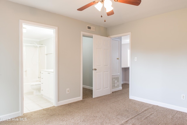 2525 Flint Dr, Wilmington, NC 28401 - unfurnished bedroom with carpet, baseboards, ensuite bathroom, and a ceiling fan