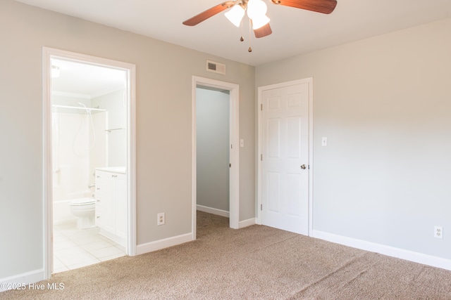 2525 Flint Dr, Wilmington, NC 28401 - unfurnished bedroom featuring light colored carpet, baseboards, ensuite bathroom, and a ceiling fan