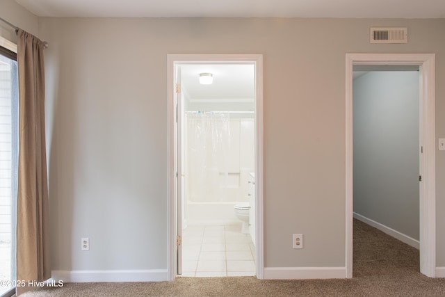 2525 Flint Dr, Wilmington, NC 28401 - unfurnished bedroom with carpet, baseboards, and tile patterned floors