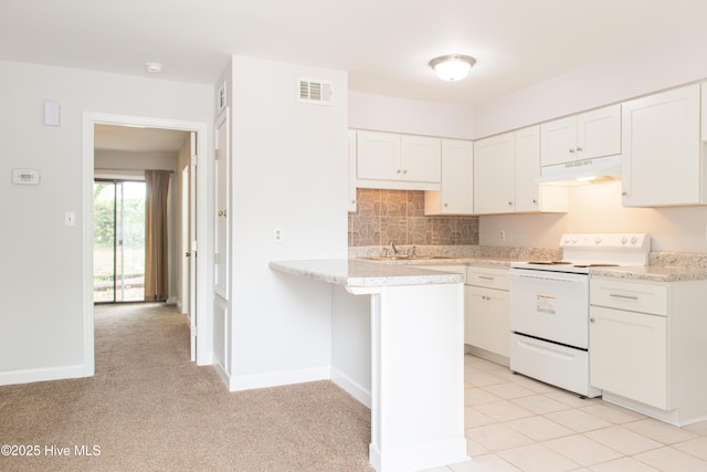 2525 Flint Dr, Wilmington, NC 28401 - kitchen with white range with electric cooktop, under cabinet range hood, white cabinetry, a peninsula, and decorative backsplash