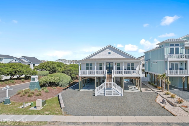 1044 Ocean Blvd W, Supply, NC 28462 - coastal home featuring a carport, driveway, stairway, and a porch