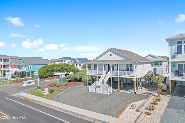 1044 Ocean Blvd W, Supply, NC 28462 - coastal inspired home with stairs, covered porch, and a residential view