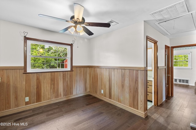350 Toulon Dr, Wilmington, NC 28405 - spare room with attic access, a wainscoted wall, dark wood finished floors, a ceiling fan, and wooden walls