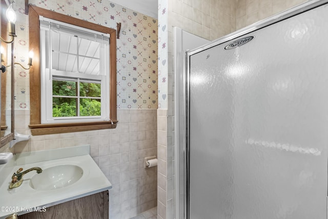 350 Toulon Dr, Wilmington, NC 28405 - bathroom with wallpapered walls, tile walls, a shower stall, vanity, and wainscoting