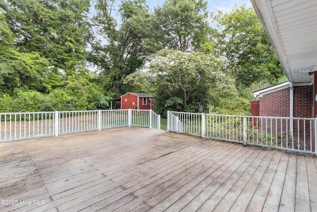 350 Toulon Dr, Wilmington, NC 28405 - wooden deck featuring view of scattered trees and a storage unit