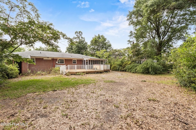 350 Toulon Dr, Wilmington, NC 28405 - rear view of house with a wooden deck, brick siding, and a sunroom