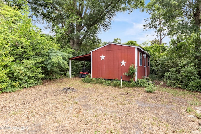 350 Toulon Dr, Wilmington, NC 28405 - view of shed featuring a carport and driveway