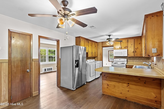 350 Toulon Dr, Wilmington, NC 28405 - kitchen with white appliances, washer and dryer, ceiling fan, a peninsula, and brown cabinetry