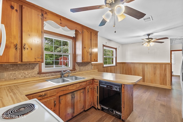 350 Toulon Dr, Wilmington, NC 28405 - kitchen with dishwasher, light countertops, a peninsula, wainscoting, and wood finished floors