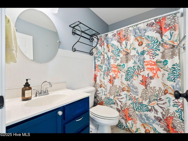406 Endicott Ct, Wilmington, NC 28411 - bathroom with vanity, wainscoting, toilet, and a shower with shower curtain