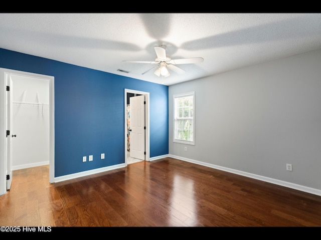 406 Endicott Ct, Wilmington, NC 28411 - unfurnished bedroom with a walk in closet, wood finished floors, and baseboards