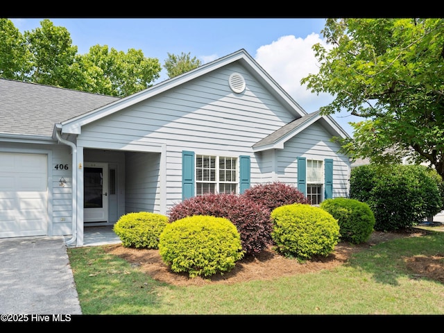 406 Endicott Ct, Wilmington, NC 28411 - view of property exterior featuring roof with shingles, a garage, and driveway