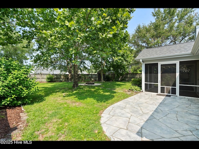 406 Endicott Ct, Wilmington, NC 28411 - view of yard featuring a sunroom, a patio, and an outdoor fire pit