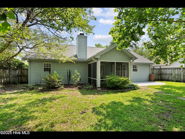 406 Endicott Ct, Wilmington, NC 28411 - rear view of house featuring a sunroom, a patio area, a chimney, and a shingled roof