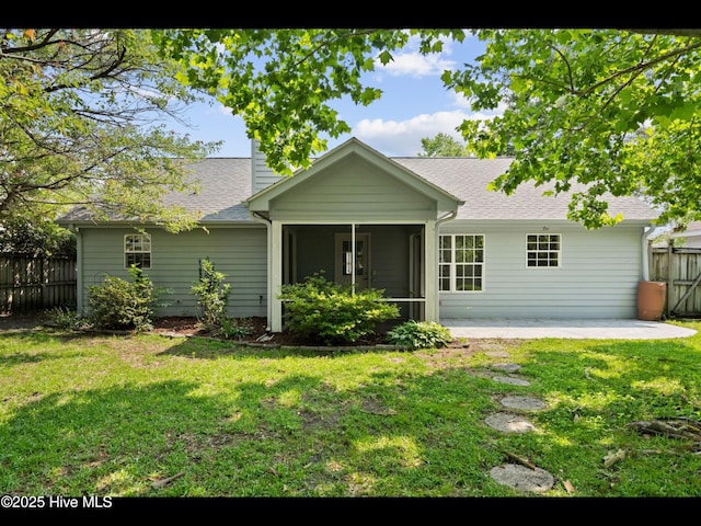 406 Endicott Ct, Wilmington, NC 28411 - view of front of home with a chimney, a sunroom, a patio area, and a shingled roof