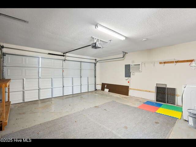 406 Endicott Ct, Wilmington, NC 28411 - garage with a garage door opener, electric panel, a wall unit AC, and washer / dryer