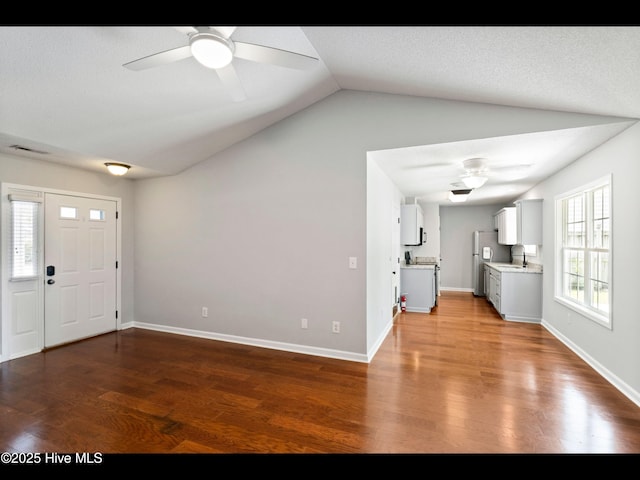 406 Endicott Ct, Wilmington, NC 28411 - unfurnished living room featuring a sink, a ceiling fan, vaulted ceiling, wood finished floors, and baseboards