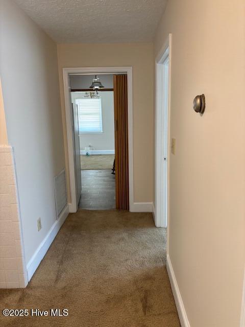 908 E 7th St, Lumberton, NC 28358 - corridor with carpet flooring and a textured ceiling