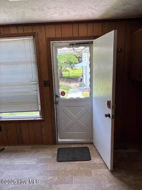 908 E 7th St, Lumberton, NC 28358 - doorway to outside with a textured ceiling and wooden walls