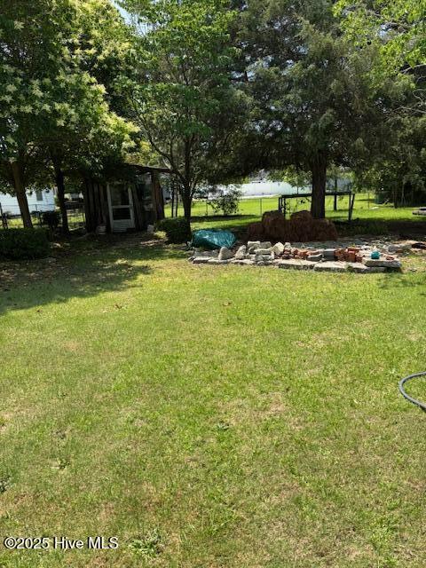 908 E 7th St, Lumberton, NC 28358 - view of grassy yard featuring a storage unit