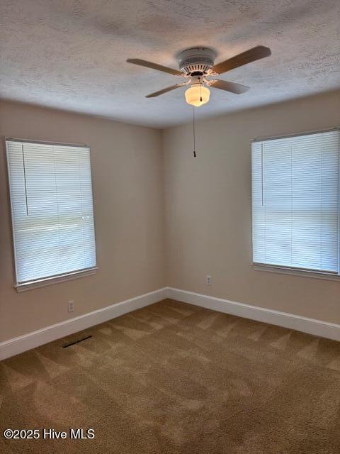 908 E 7th St, Lumberton, NC 28358 - carpeted empty room with a textured ceiling, plenty of natural light, and ceiling fan