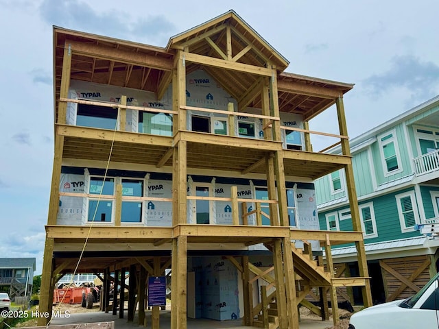 2916 E Beach Dr, Oak Island, NC 28465 - back of house featuring a carport and a garage
