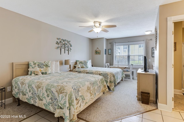330 S Middleton Dr NW Unit 1201, Calabash, NC 28467 - bedroom featuring light tile patterned floors, ceiling fan, baseboards, a textured ceiling, and light colored carpet