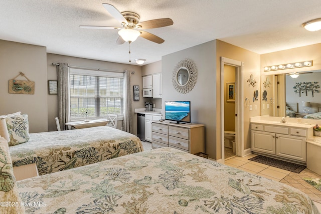 330 S Middleton Dr NW Unit 1201, Calabash, NC 28467 - bedroom with a sink, a textured ceiling, light tile patterned floors, connected bathroom, and ceiling fan