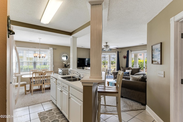 330 S Middleton Dr NW Unit 1201, Calabash, NC 28467 - kitchen featuring open floor plan, a sink, light tile patterned floors, dishwasher, and decorative columns