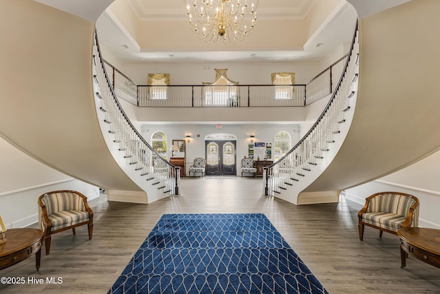 330 S Middleton Dr NW Unit 1201, Calabash, NC 28467 - foyer featuring stairway, crown molding, a chandelier, arched walkways, and wood finished floors