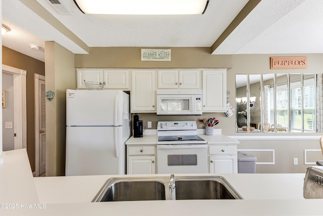 330 S Middleton Dr NW Unit 1201, Calabash, NC 28467 - kitchen featuring white appliances, a sink, light countertops, and white cabinetry