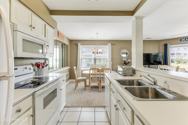 330 S Middleton Dr NW Unit 1201, Calabash, NC 28467 - kitchen with white appliances, a sink, light colored carpet, light countertops, and white cabinetry