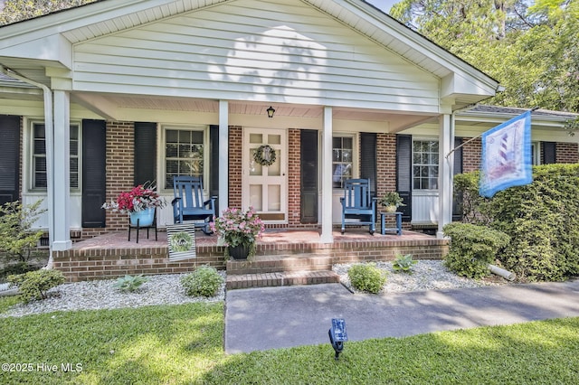 1409 Knollwood Dr NW, Wilson, NC 27896 - view of front of property with a porch and brick siding