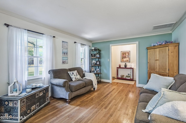 1409 Knollwood Dr NW, Wilson, NC 27896 - living area featuring ornamental molding, light wood-style flooring, and baseboards