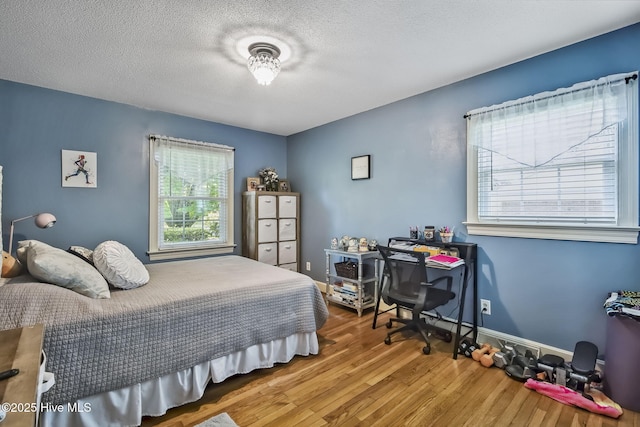 1409 Knollwood Dr NW, Wilson, NC 27896 - bedroom featuring wood finished floors, a textured ceiling, and baseboards