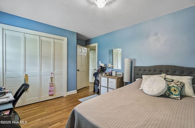 1409 Knollwood Dr NW, Wilson, NC 27896 - bedroom with wood finished floors, a closet, a textured ceiling, and baseboards